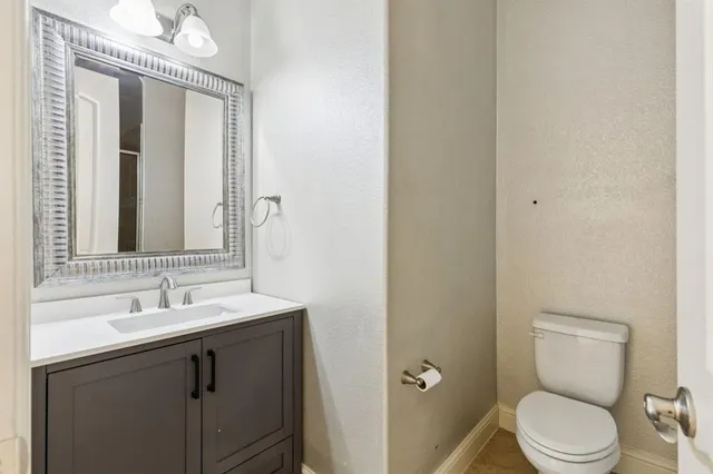 a bathroom with a toilet a sink a mirror and a shower