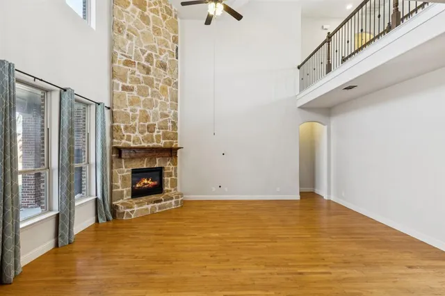 a view of an empty room with window and fire place