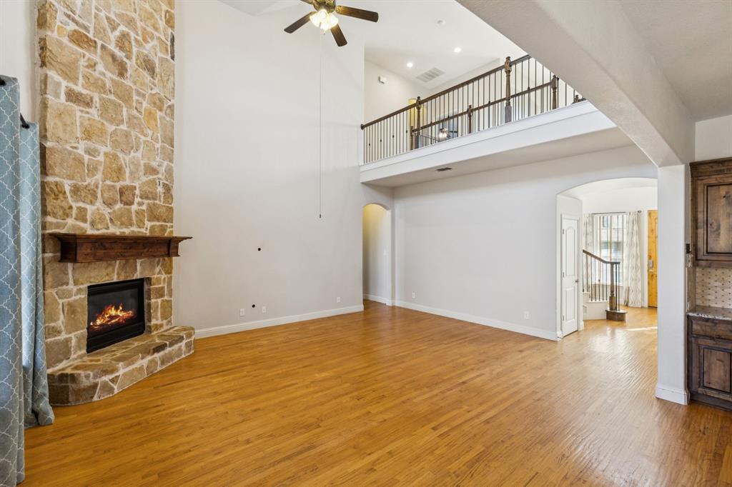 10234 Cava Road Frisco, TX 75035 - Photo 10 of 40 a view of empty room with wooden floor and fireplace