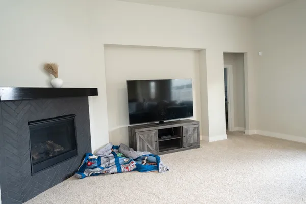 a living room with furniture and kitchen view