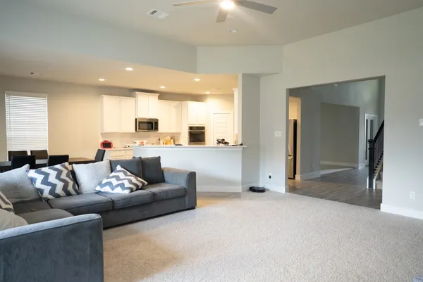 a living room with couches and a large window