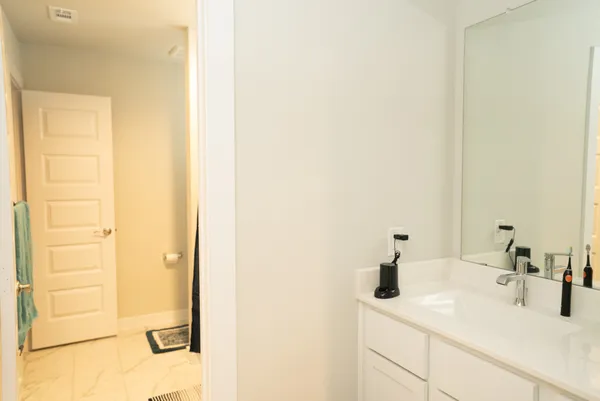 a white toilet sitting next to a bath tub