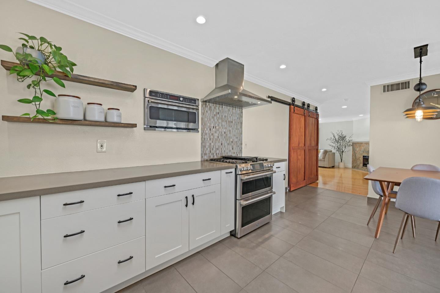 2514 Heatherlark Circle Pleasanton, CA 94566 - Photo 14 of 40 a kitchen with granite countertop a stove and white cabinets