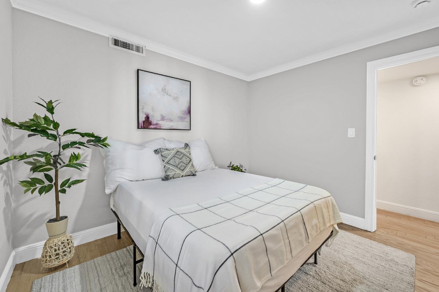 2514 Heatherlark Circle Pleasanton, CA 94566 - Photo 17 of 40 a bedroom with a bed and a potted plant