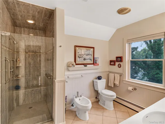 a bathroom with a toilet sink and shower