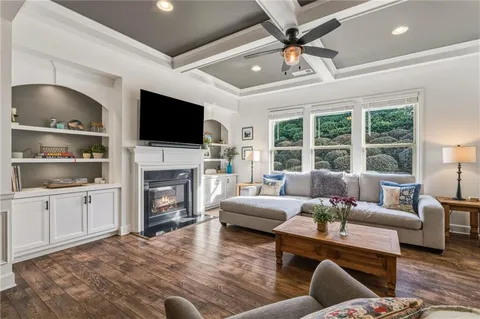 a dining room with furniture and a floor to ceiling window