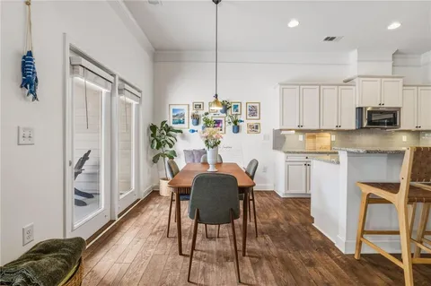 a kitchen with granite countertop white cabinets and stainless steel appliances