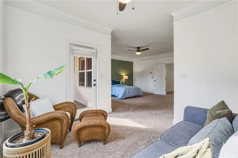 a bedroom with a bed bookshelf and a window