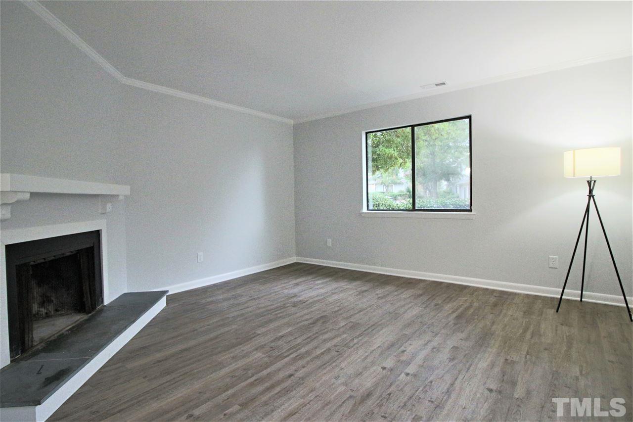 5815 Shady Grove Circle Raleigh, NC 27609 - Photo 1 of 19 a view of an empty room with wooden floor and a window