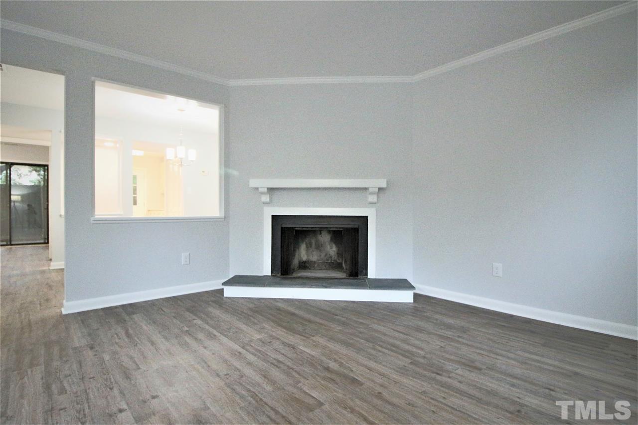 5815 Shady Grove Circle Raleigh, NC 27609 - Photo 2 of 19 a view of an empty room with wooden floor and a window