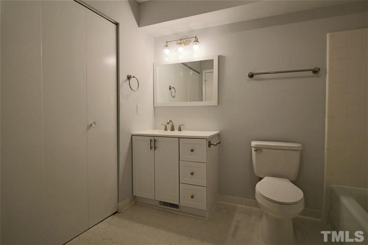 5815 Shady Grove Circle Raleigh, NC 27609 - Photo 14 of 19 a bathroom with a toilet sink and mirror