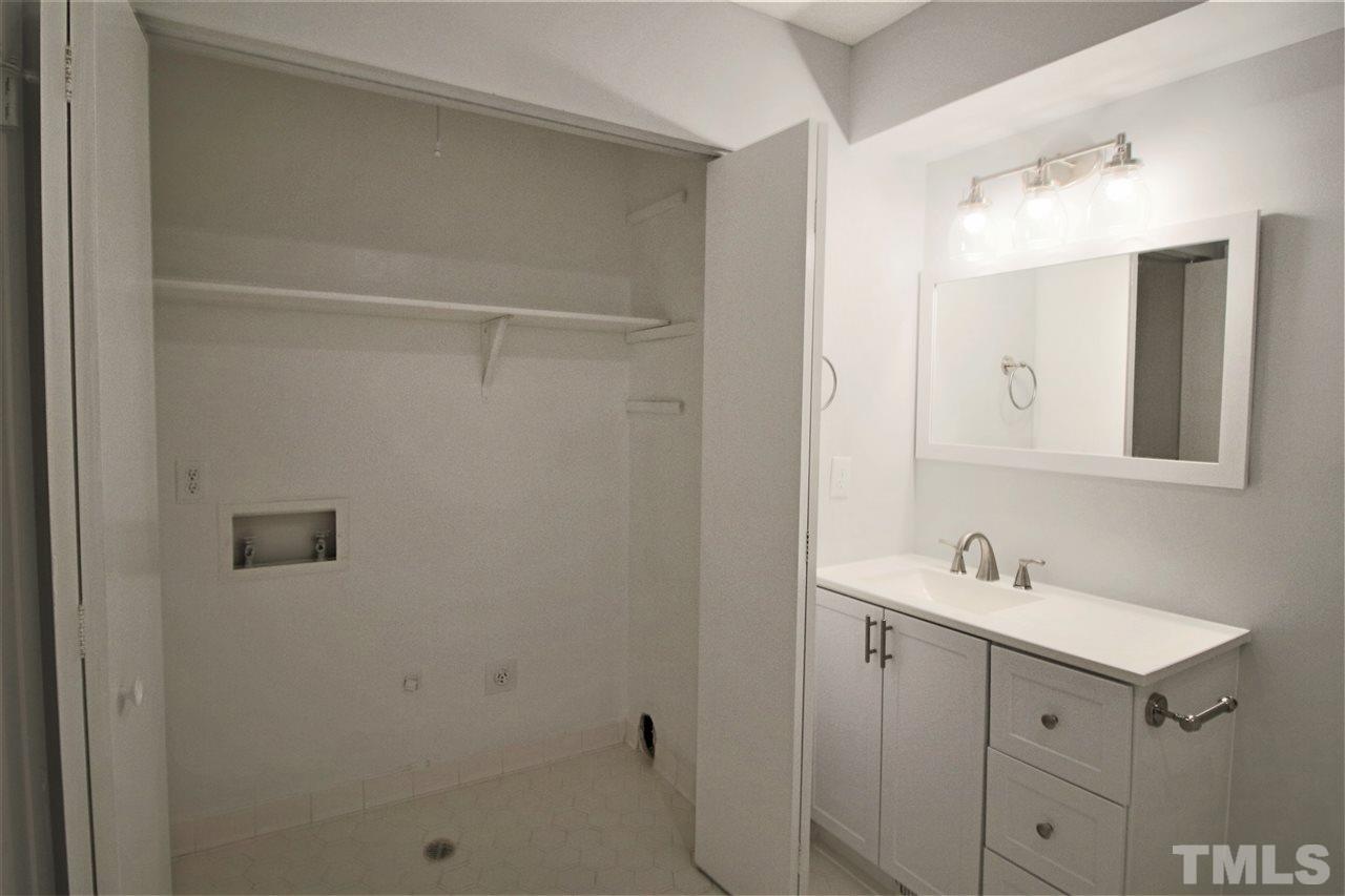 5815 Shady Grove Circle Raleigh, NC 27609 - Photo 16 of 19 a bathroom with a sink and a mirror