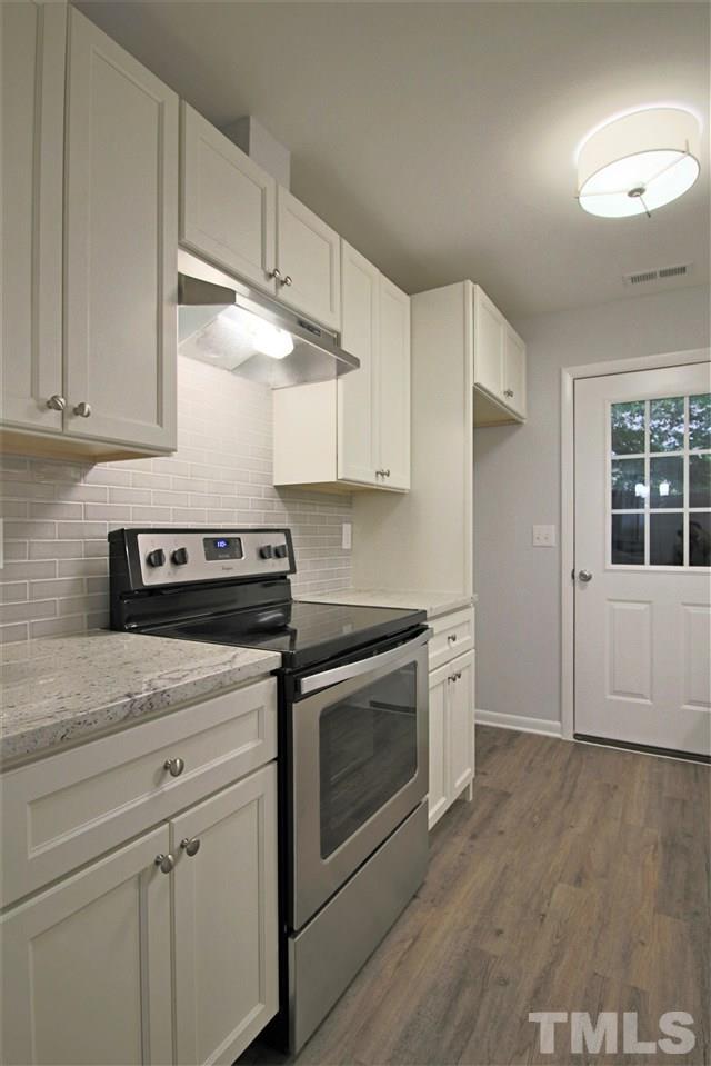 5815 Shady Grove Circle Raleigh, NC 27609 - Photo 4 of 19 a kitchen with granite countertop a stove and a sink