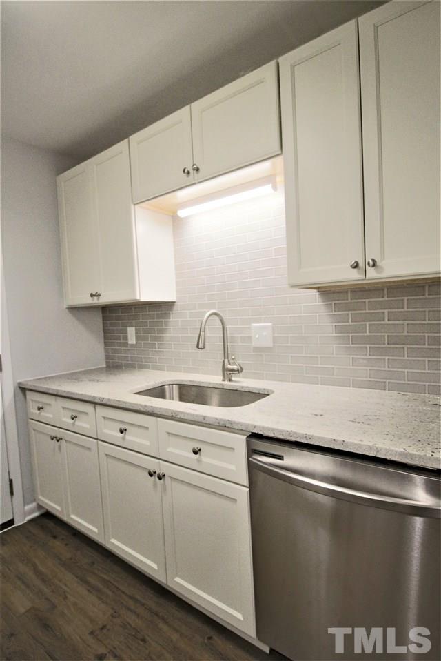 5815 Shady Grove Circle Raleigh, NC 27609 - Photo 5 of 19 a kitchen with granite countertop white cabinets and a sink