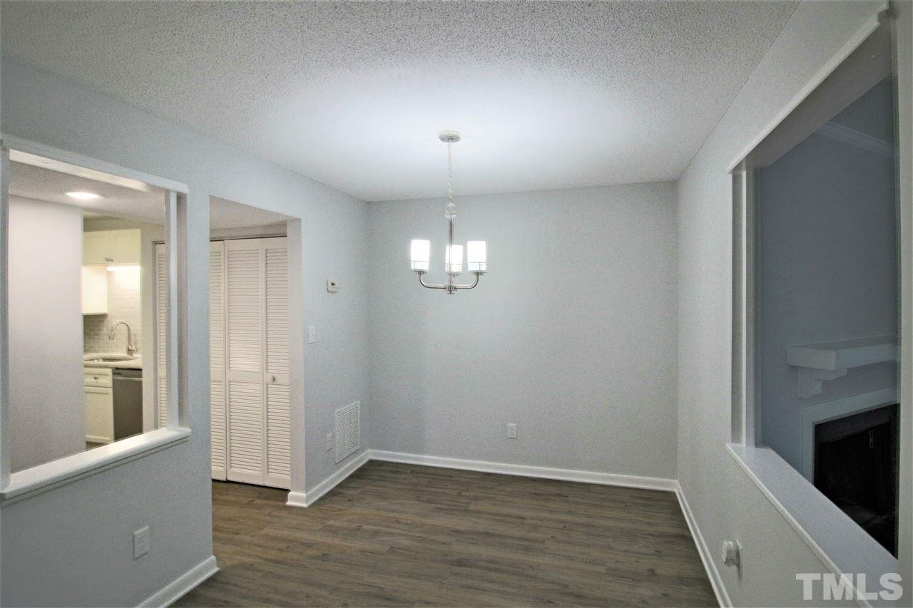 5815 Shady Grove Circle Raleigh, NC 27609 - Photo 7 of 19 an empty room with wooden floor and windows