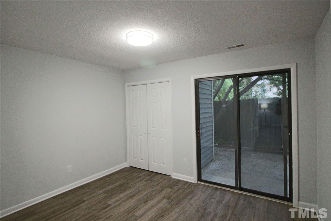 5815 Shady Grove Circle Raleigh, NC 27609 - Photo 8 of 19 an empty room with wooden floor and windows