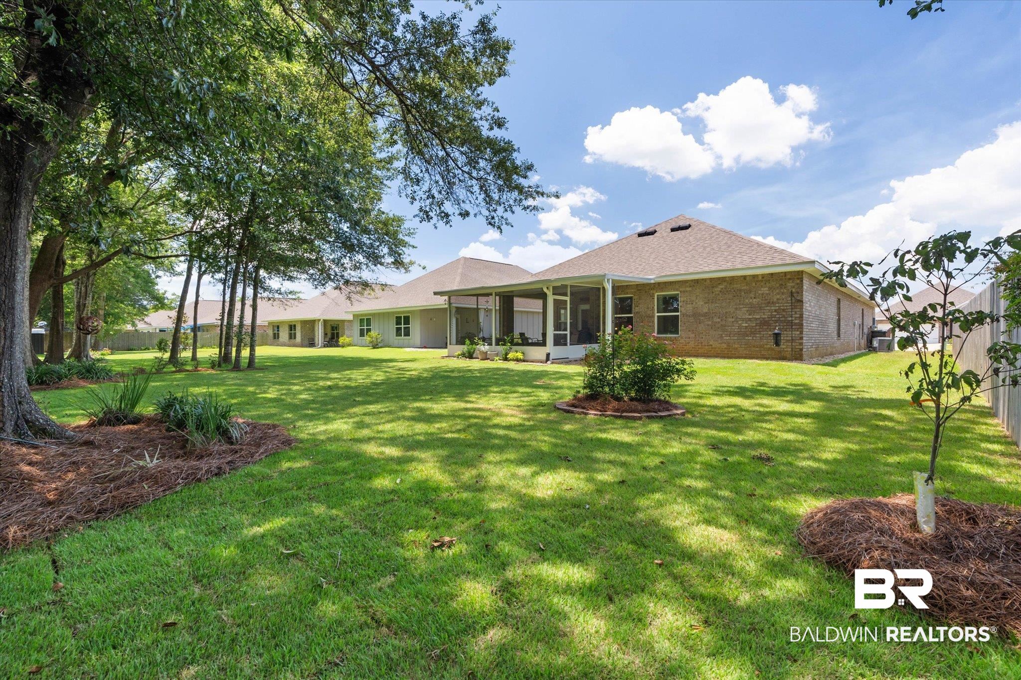 9037 Impala Drive Foley, AL 36535 - Photo 15 of 21 Rear view of property featuring brick siding, a yard, a sunroom, and roof with shingles
