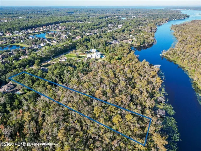 an aerial view of a house with a lake view