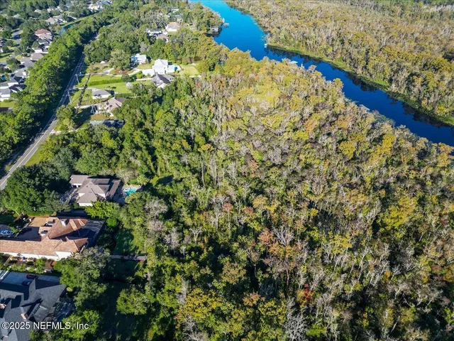 an aerial view of a house with a lake view
