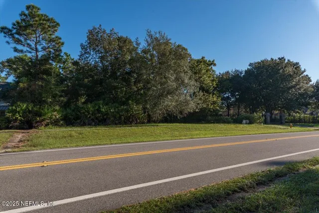 an aerial view of a house with a yard and lake view