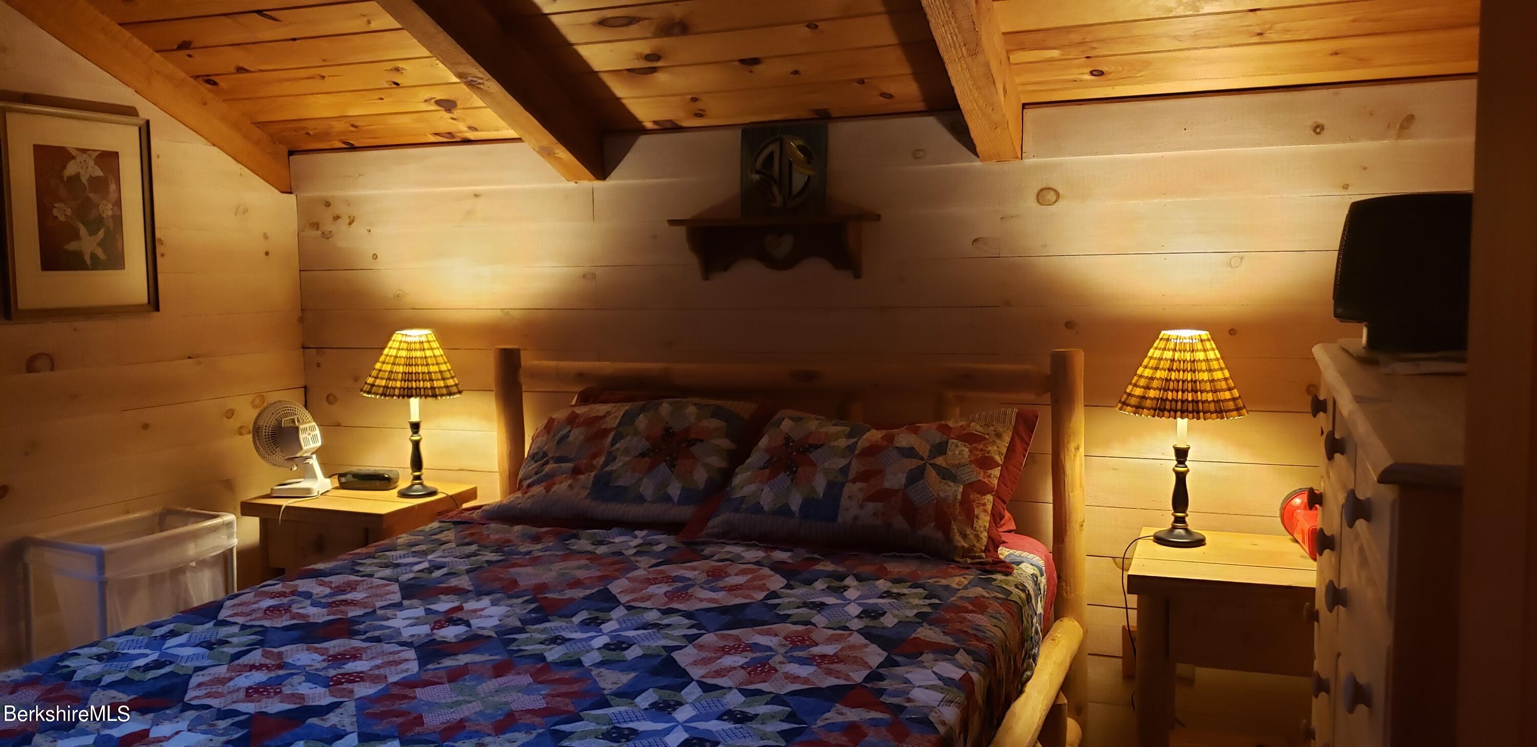 110 Strykers Road Florida, MA 01247 - Photo 15 of 20 a bed sitting in a bedroom next to a window