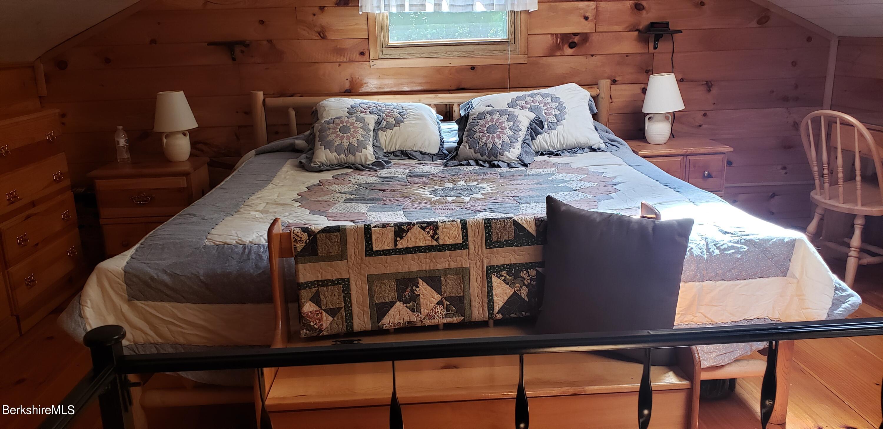 110 Strykers Road Florida, MA 01247 - Photo 17 of 20 a bed sitting in a bedroom next to a window