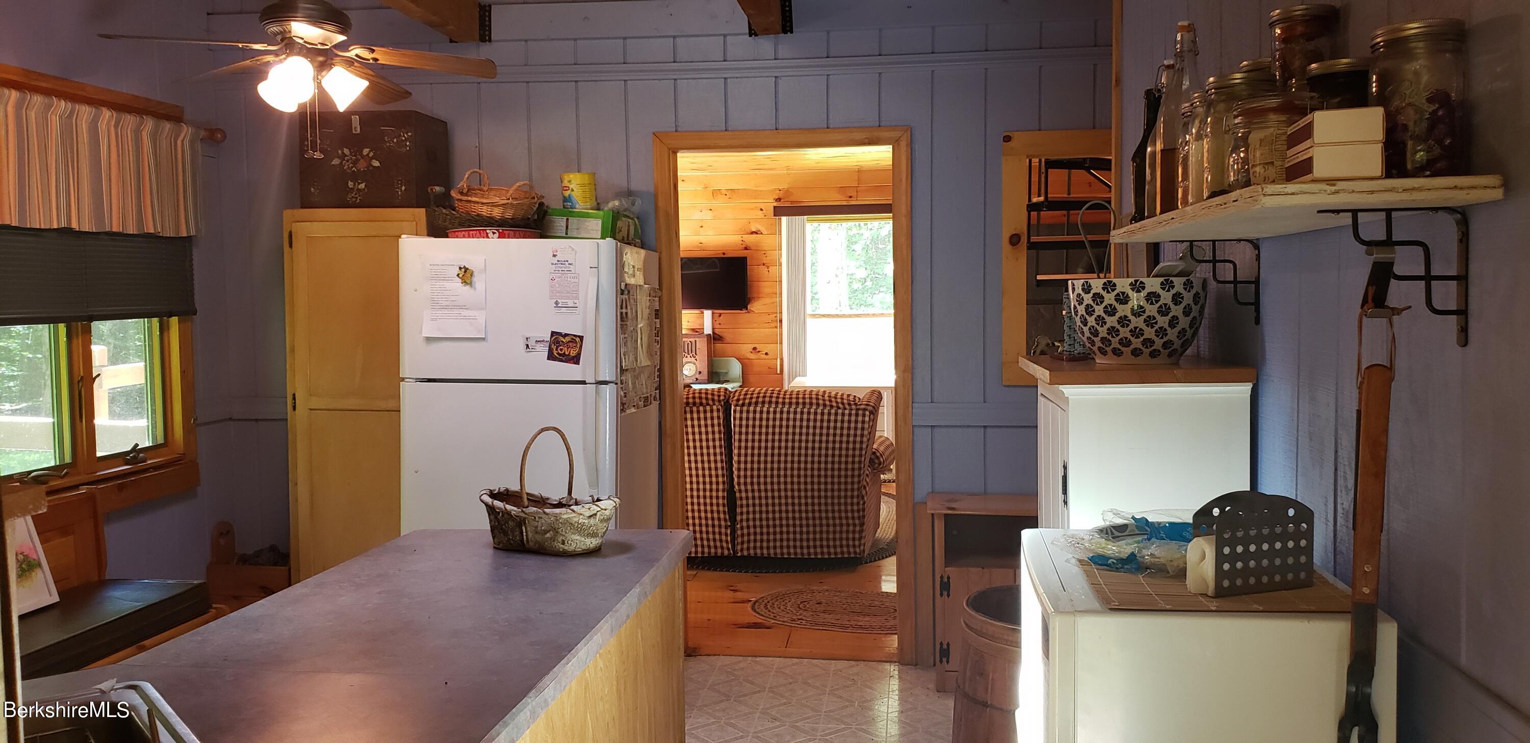 110 Strykers Road Florida, MA 01247 - Photo 9 of 20 a kitchen with a refrigerator and a stove
