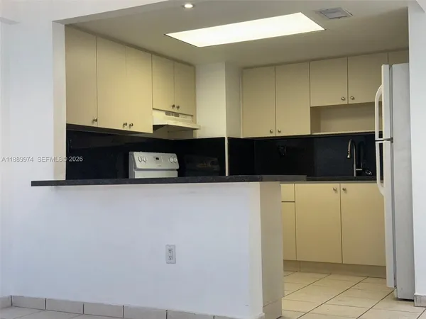 a kitchen with granite countertop a sink and a stove