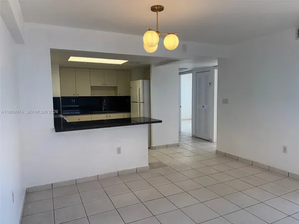 a kitchen with stainless steel appliances a refrigerator and cabinets
