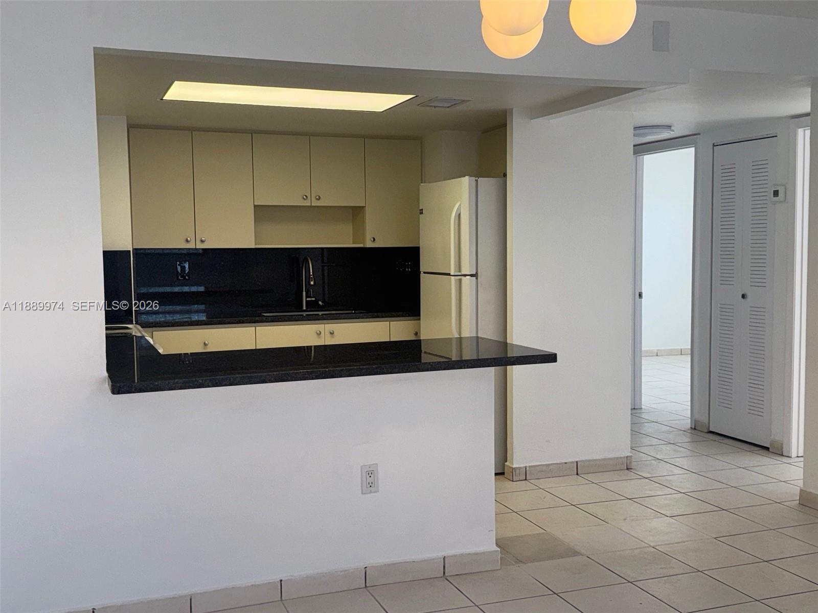 3945 Southwest 89th Avenue, Unit 201 Miami, FL 33165 - Photo 19 of 24 a kitchen with stainless steel appliances a refrigerator and cabinets