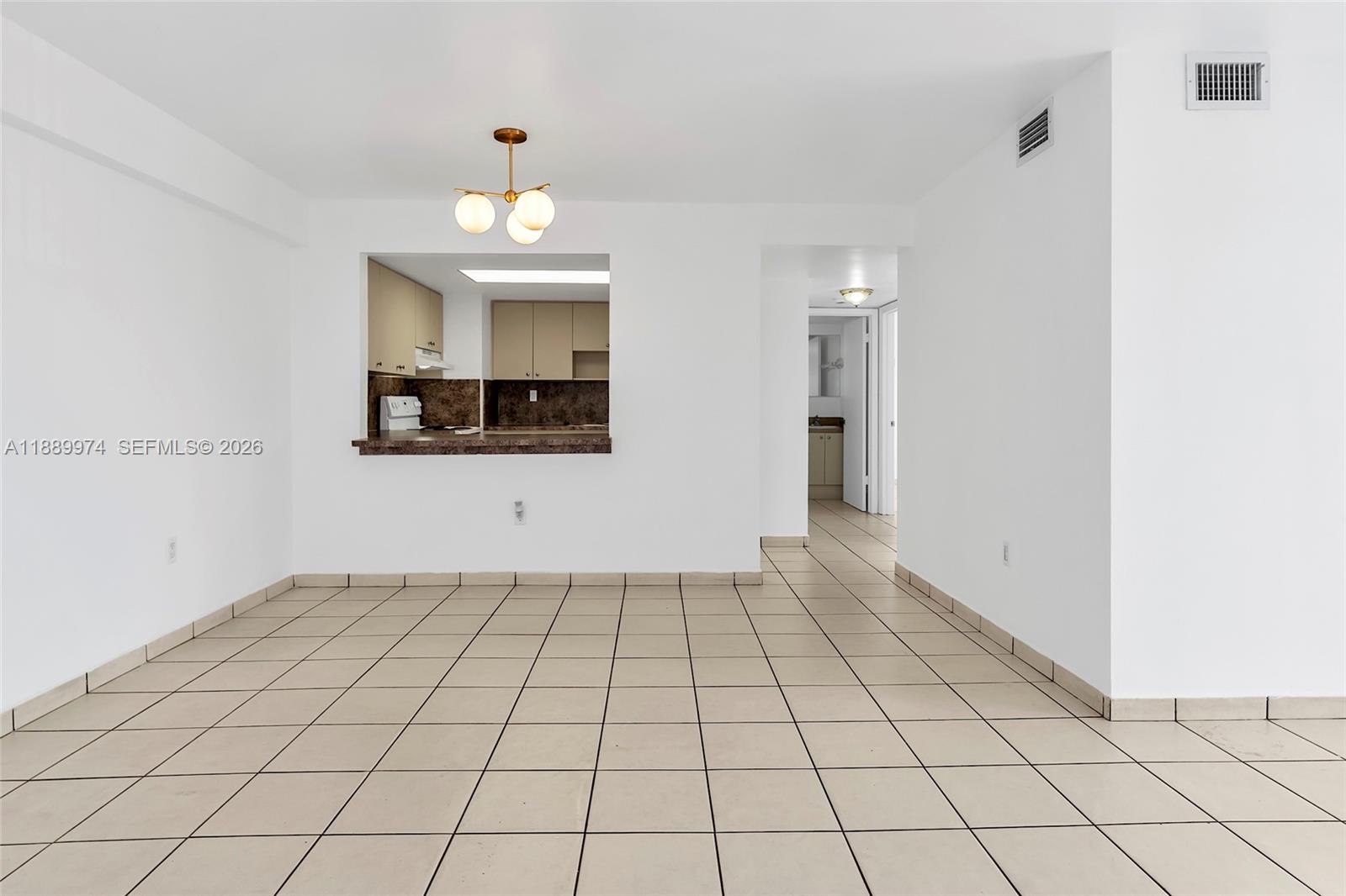 3945 Southwest 89th Avenue, Unit 201 Miami, FL 33165 - Photo 4 of 24 wooden floor in an empty room with a window