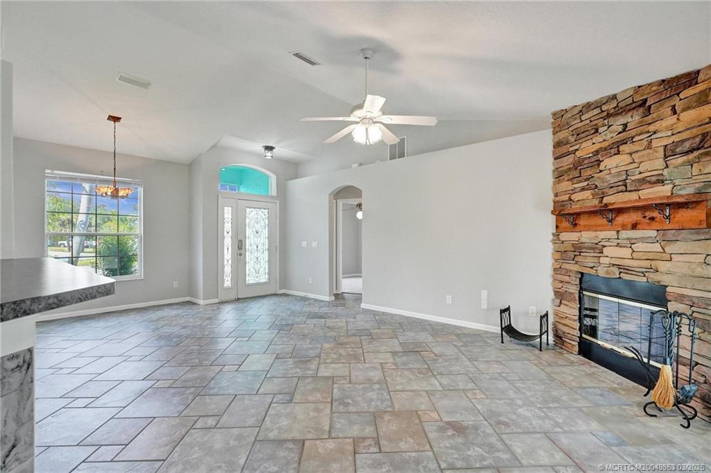 5902 Yucca Drive Fort Pierce, FL 34982 - Photo 11 of 83 a view of an empty room with a fireplace and a window
