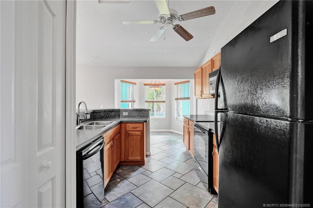 5902 Yucca Drive Fort Pierce, FL 34982 - Photo 14 of 83 a kitchen with stainless steel appliances granite countertop a refrigerator a stove and a sink
