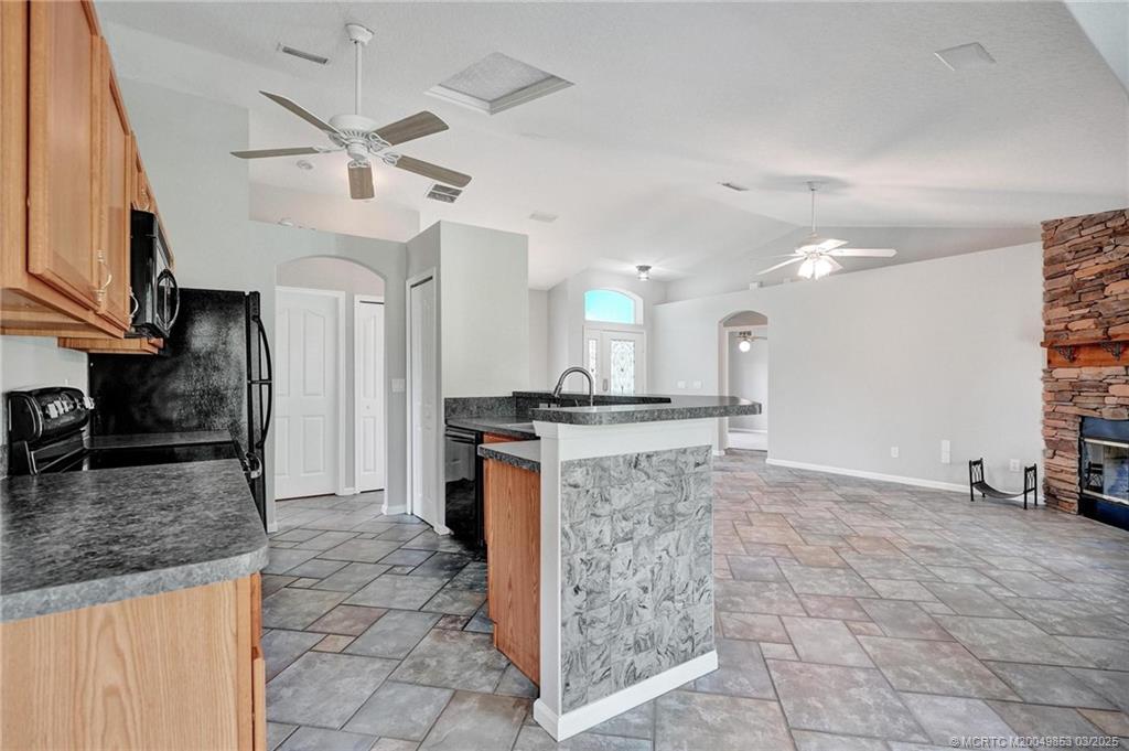 5902 Yucca Drive Fort Pierce, FL 34982 - Photo 17 of 83 a kitchen with granite countertop a sink cabinets and stainless steel appliances