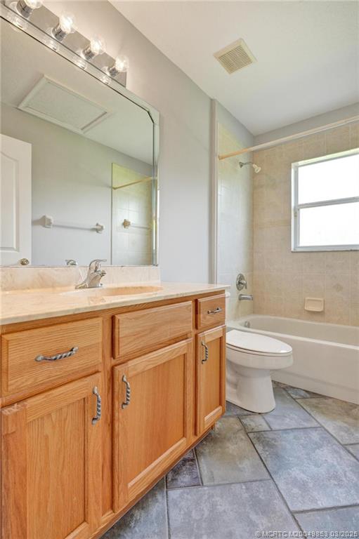 5902 Yucca Drive Fort Pierce, FL 34982 - Photo 22 of 83 a bathroom with a toilet a sink a tub and a mirror