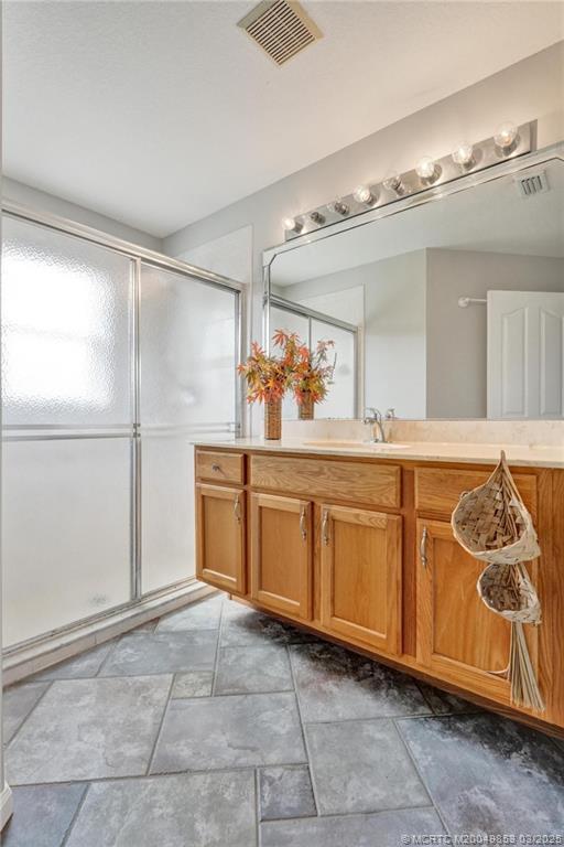 5902 Yucca Drive Fort Pierce, FL 34982 - Photo 34 of 83 a bathroom with a sink a mirror and a shower