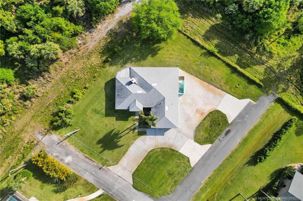 5902 Yucca Drive Fort Pierce, FL 34982 - Photo 51 of 83 an aerial view of a house with a yard and trees