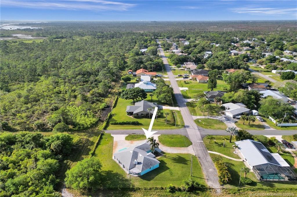5902 Yucca Drive Fort Pierce, FL 34982 - Photo 56 of 83 an aerial view of residential houses with outdoor space and trees