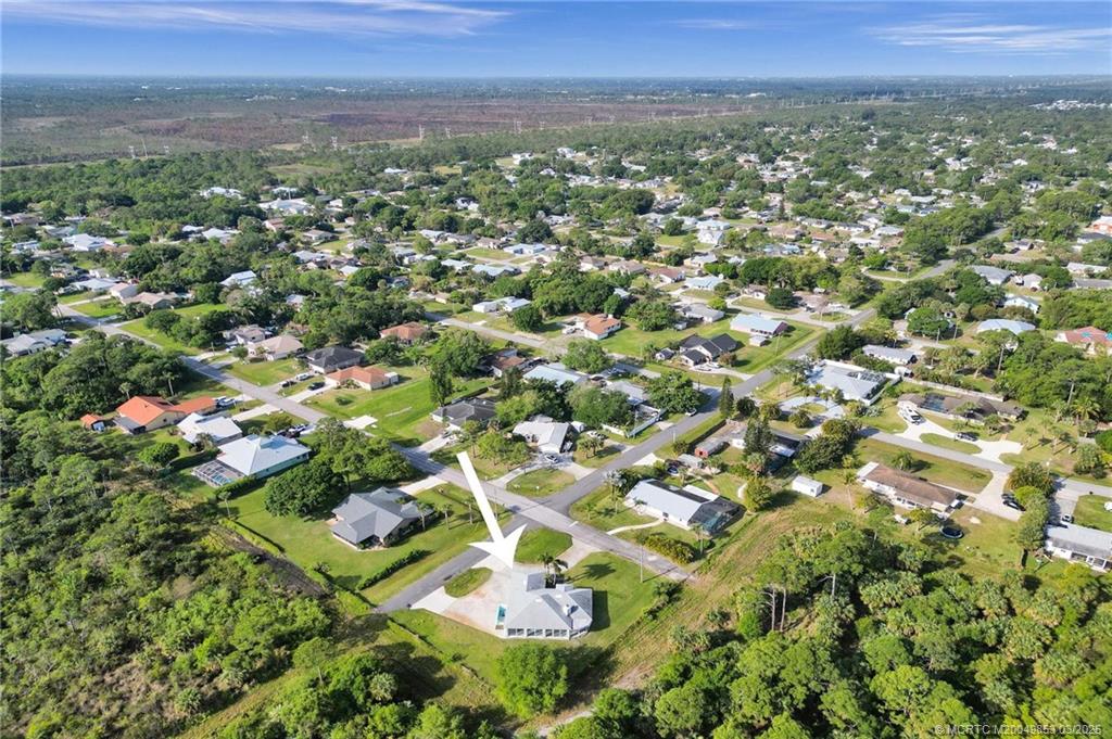 5902 Yucca Drive Fort Pierce, FL 34982 - Photo 57 of 83 an aerial view of residential houses with outdoor space and trees