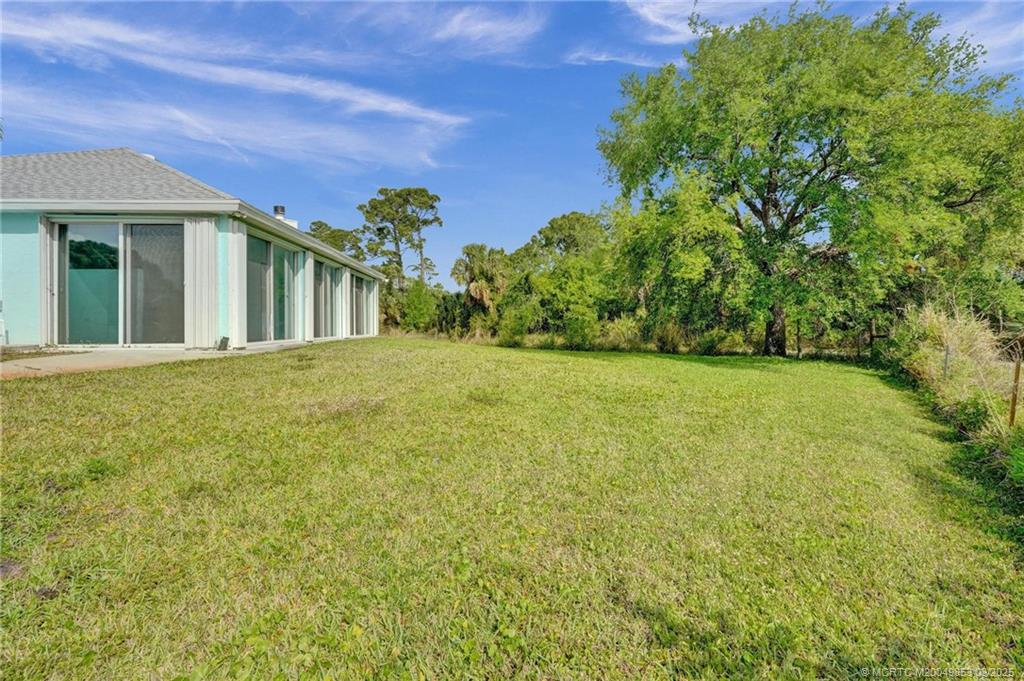 5902 Yucca Drive Fort Pierce, FL 34982 - Photo 64 of 83 a view of a big house with a big yard and large trees