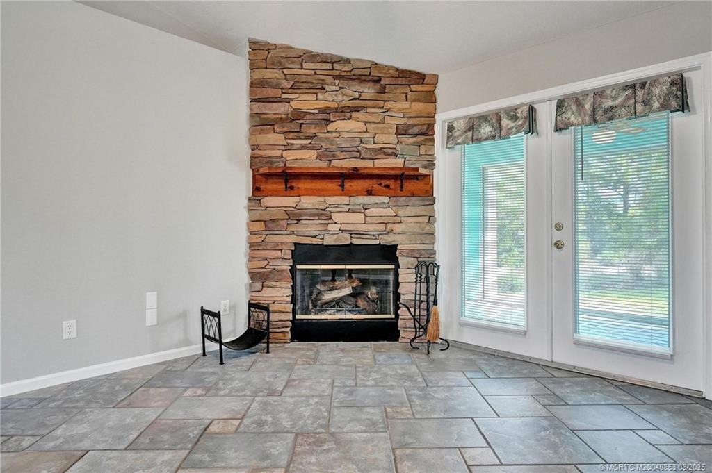 5902 Yucca Drive Fort Pierce, FL 34982 - Photo 9 of 83 a living room with furniture a fireplace and a table