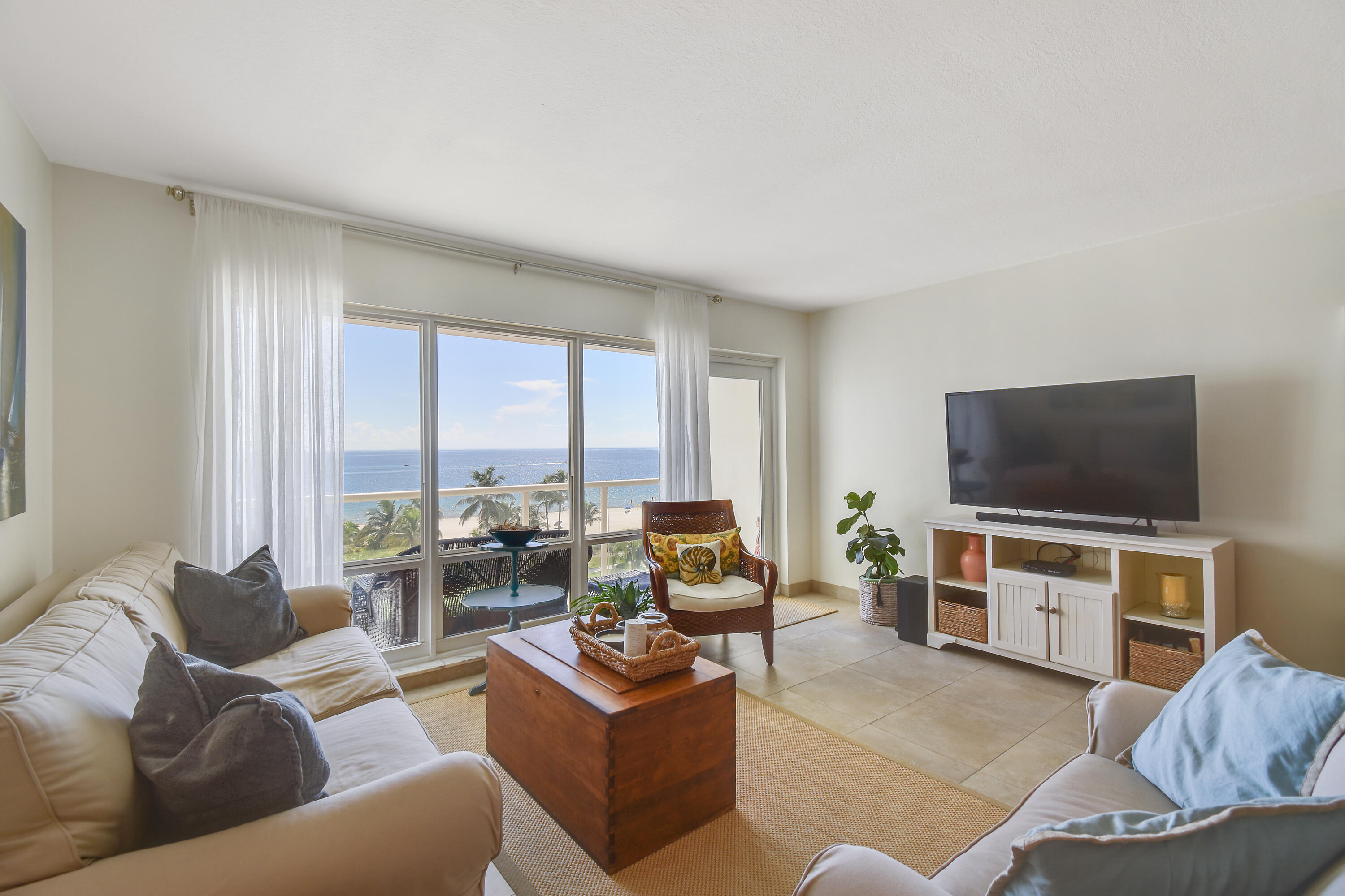 111 North Pompano Beach Boulevard, Unit 811 Pompano Beach, FL 33062 - Photo 9 of 24 a living room with furniture and a flat screen tv