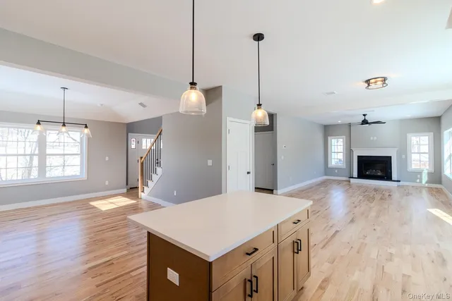 a kitchen with a wooden floor and a fireplace
