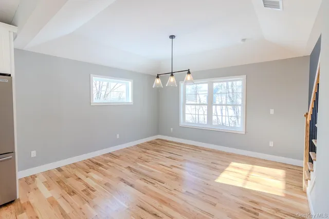 a view of a kitchen with wooden floor and a sink