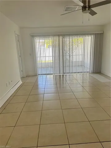 a view of a livingroom with a floor to ceiling window and carpet
