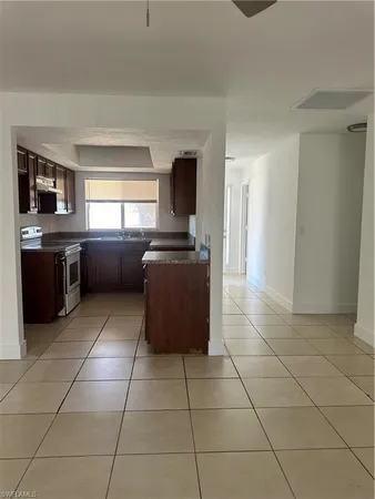 a kitchen with granite countertop a sink and a counter top space