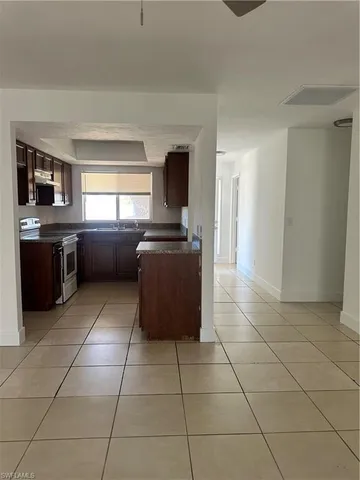 a kitchen with granite countertop a sink and a counter top space