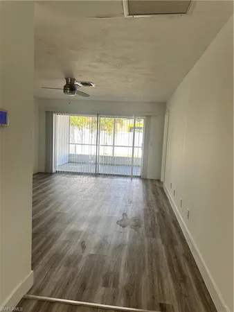a view of an empty room and a window
