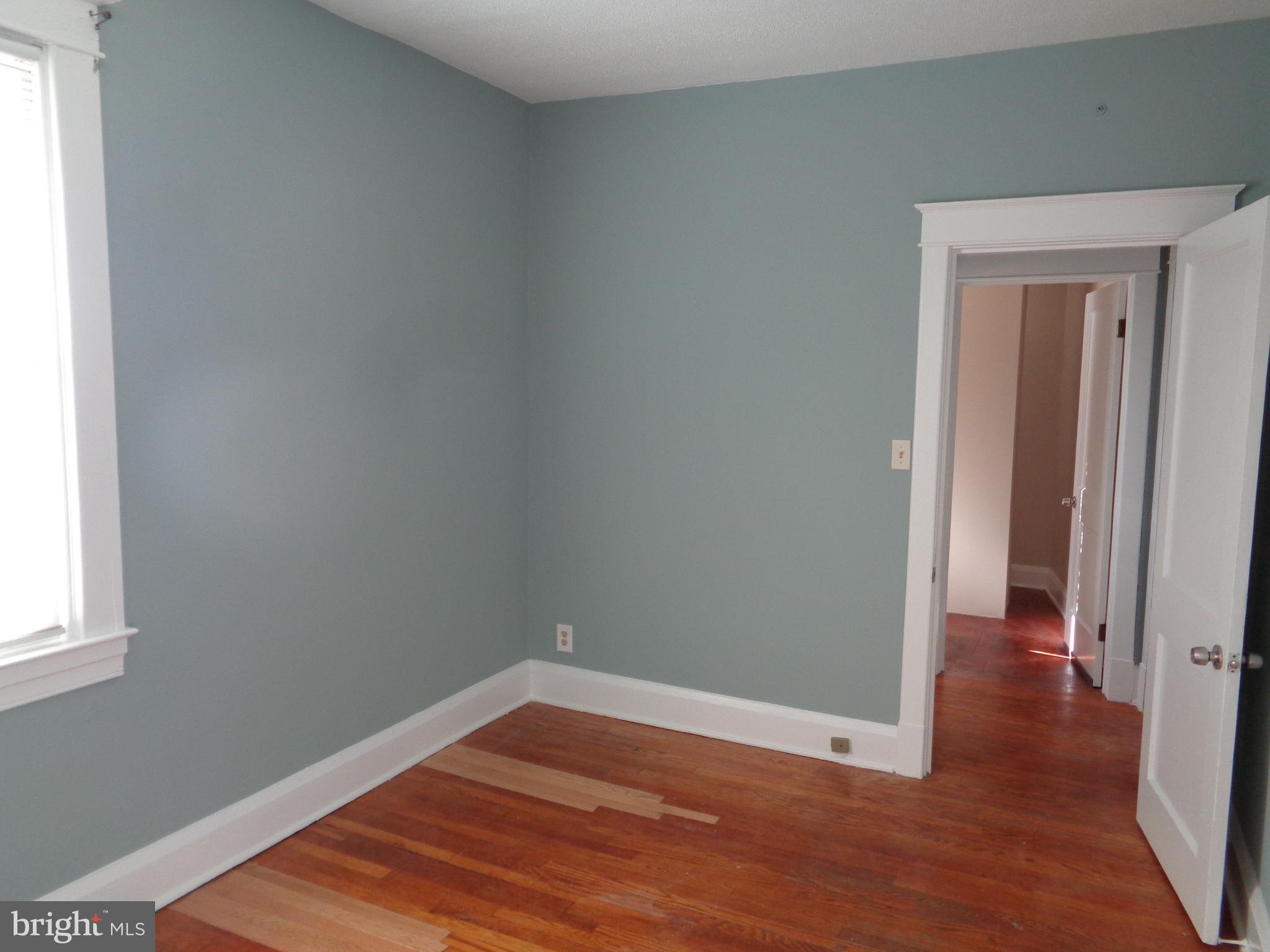 2800 Linwood Avenue, Unit C Baltimore, MD 21234 - Photo 11 of 18 a view of a room with wooden floor and white walls