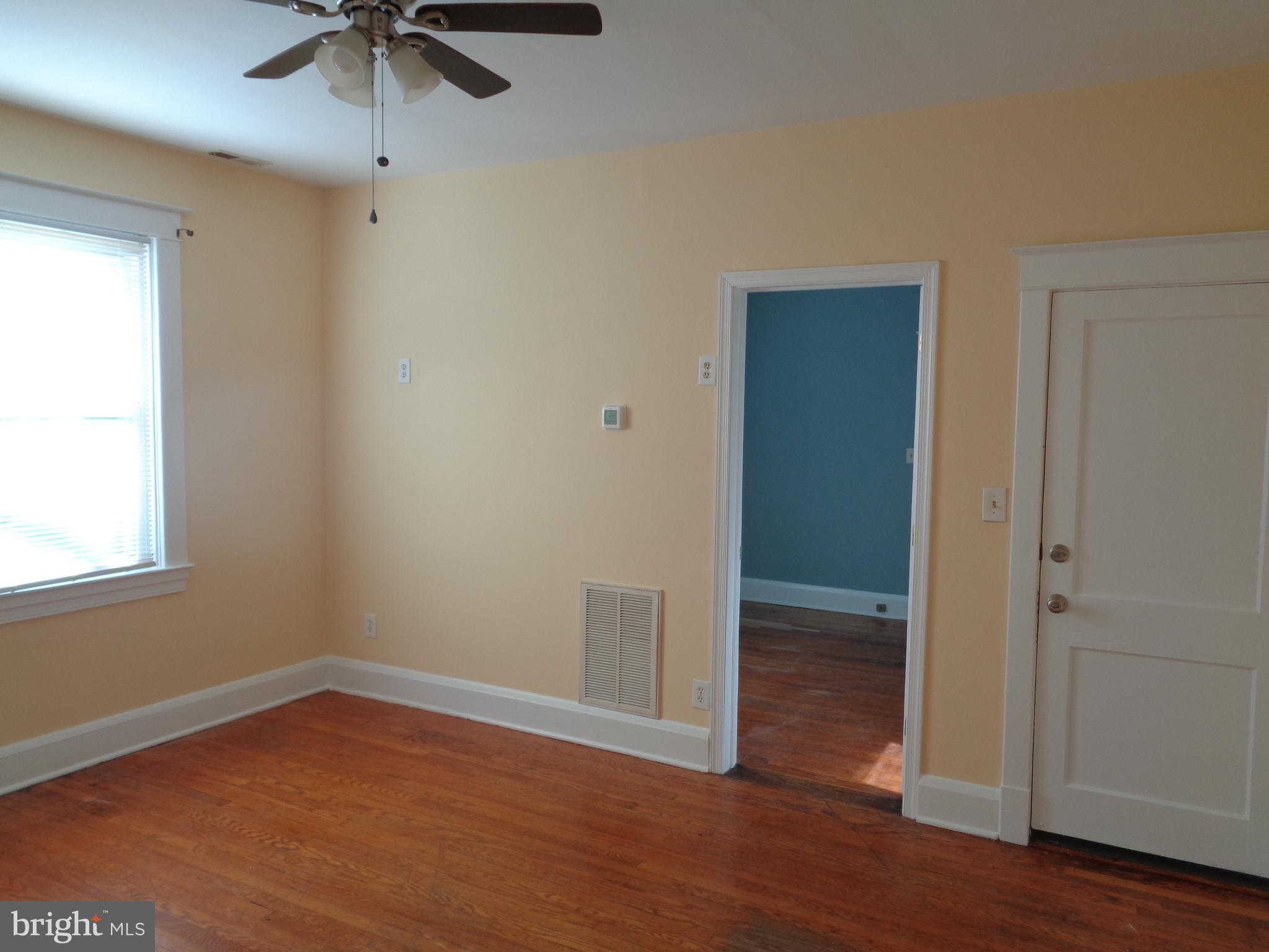 2800 Linwood Avenue, Unit C Baltimore, MD 21234 - Photo 2 of 18 an empty room with wooden floor fan and windows